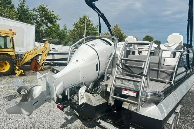 Slide: The Image of 2021 Godfrey Monaco 235RL Tri Toon boat with powerful outboard motor, parked outdoors. - 3