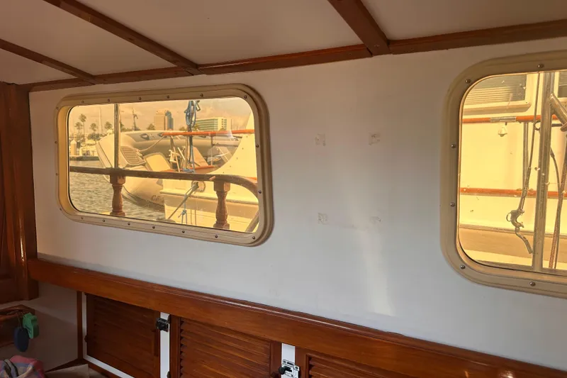 Slide: The Image of Interior view of 1978 Tayana Mariner sailboat with windows overlooking marina. - 22