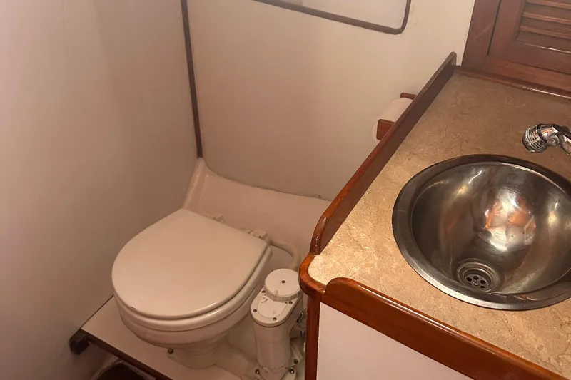 Slide: The Image of 1978 Tayana Mariner bathroom with toilet and stainless steel sink. - 31