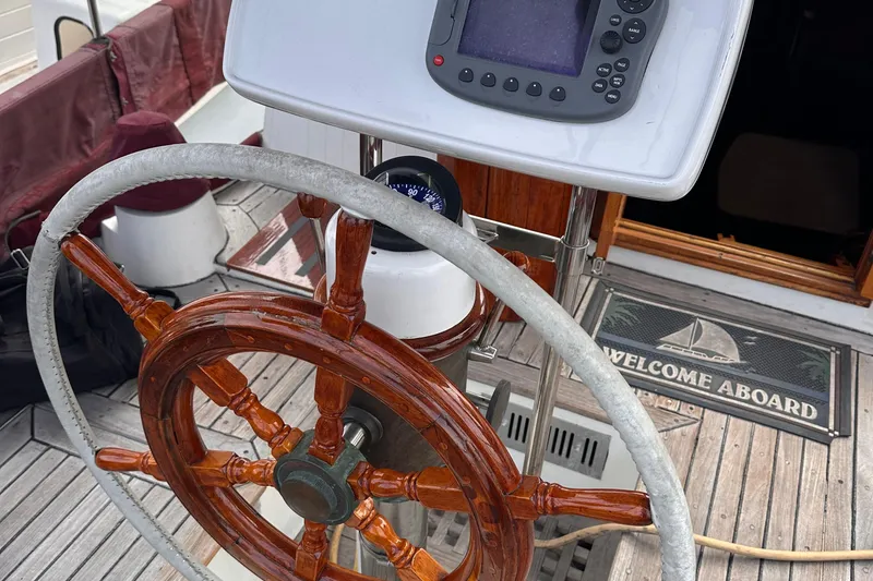 Slide: The Image of Wooden helm of a 1978 Tayana Mariner sailboat with navigation equipment. - 7
