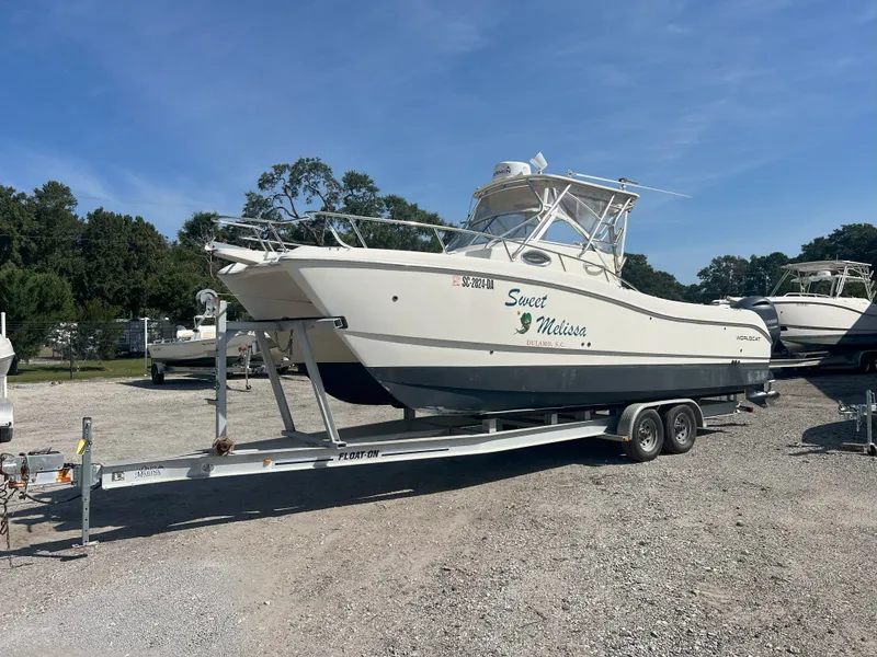 The Image of 2002 World Cat 266SC boat parked on trailer outdoors. - 1
