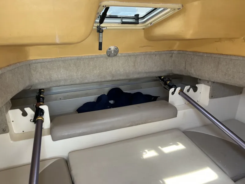 Slide: The Image of Interior of a 2002 World Cat 266SC boat with fishing rod holders. - 8