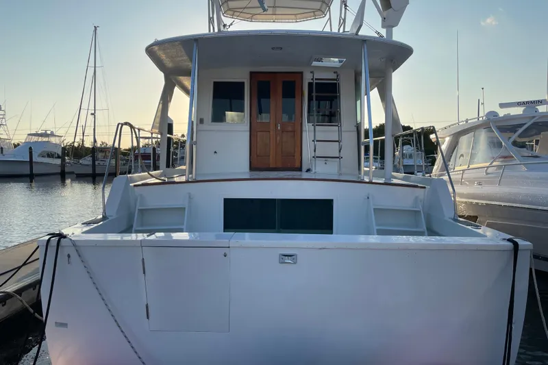 Slide: The Image of 1973 Hatteras 58 Yacht Fisherman docked at marina, rear view. - 11