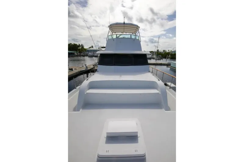 Slide: The Image of 1973 Hatteras 58 Yacht Fisherman docked, showcasing sleek design and spacious deck. - 25