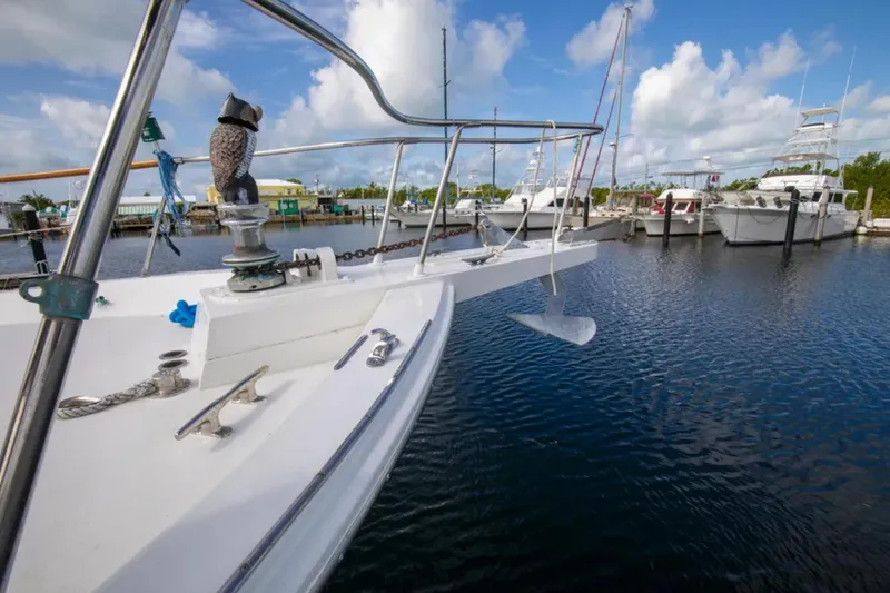 Slide: The Image of 1973 Hatteras 58 Yacht Fisherman docked in a marina under a blue sky. - 28