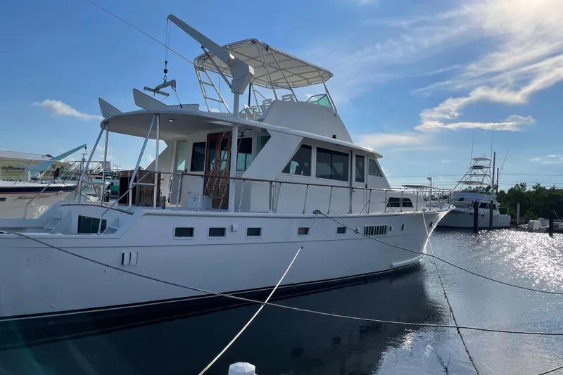 Slide: The Image of 1973 Hatteras 58 Yacht Fisherman docked in a sunny marina. - 3