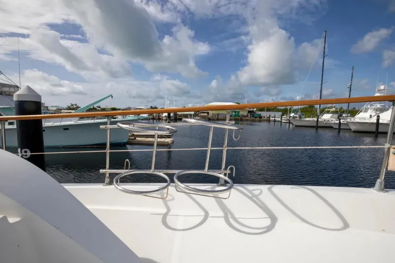 Slide: The Image of 1973 Hatteras 58 Yacht Fisherman docked at marina under blue sky. - 30