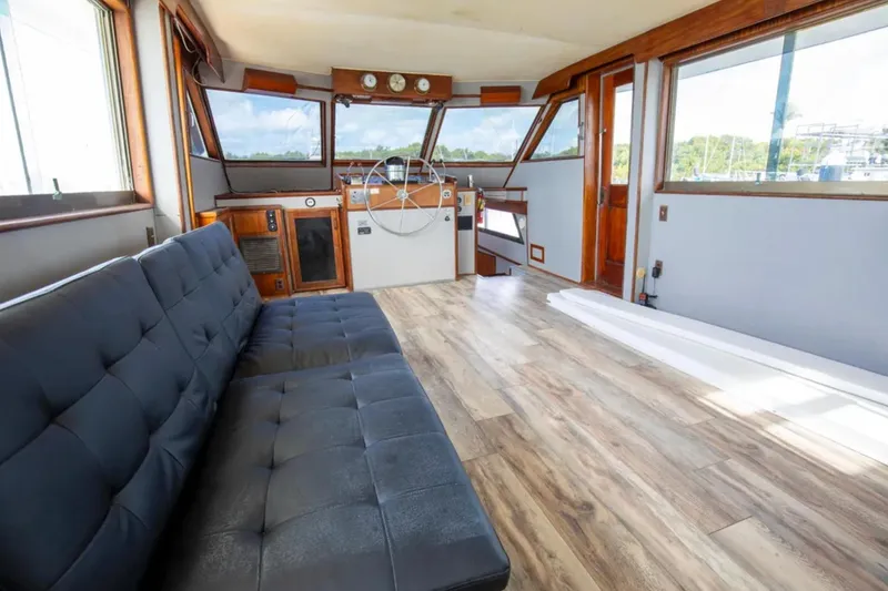 Slide: The Image of Interior of 1973 Hatteras 58 Yacht Fisherman with modern seating and wooden flooring. - 32