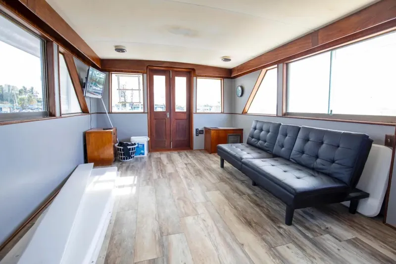 Slide: The Image of 1973 Hatteras 58 Yacht Fisherman interior with modern seating and wood accents. - 33