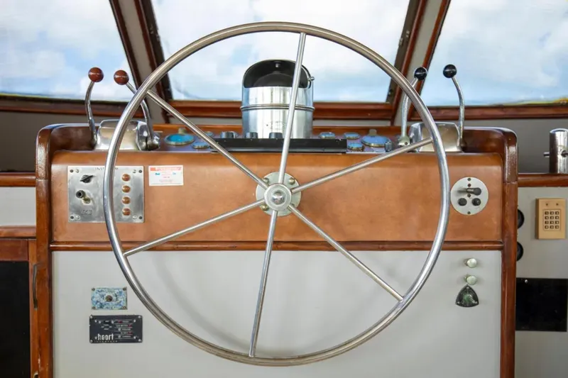 Slide: The Image of 1973 Hatteras 58 Yacht Fisherman helm with classic steering wheel and controls. - 36