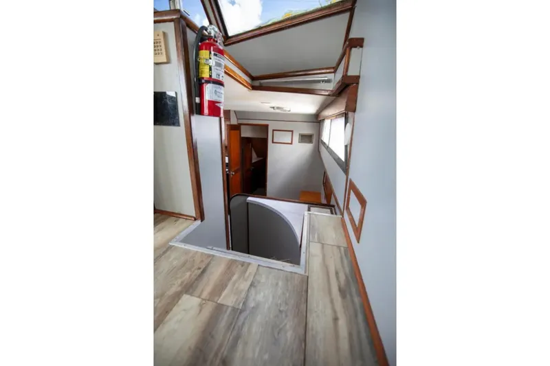 Slide: The Image of Interior view of 1973 Hatteras 58 Yacht Fisherman, featuring wooden flooring and staircase. - 41