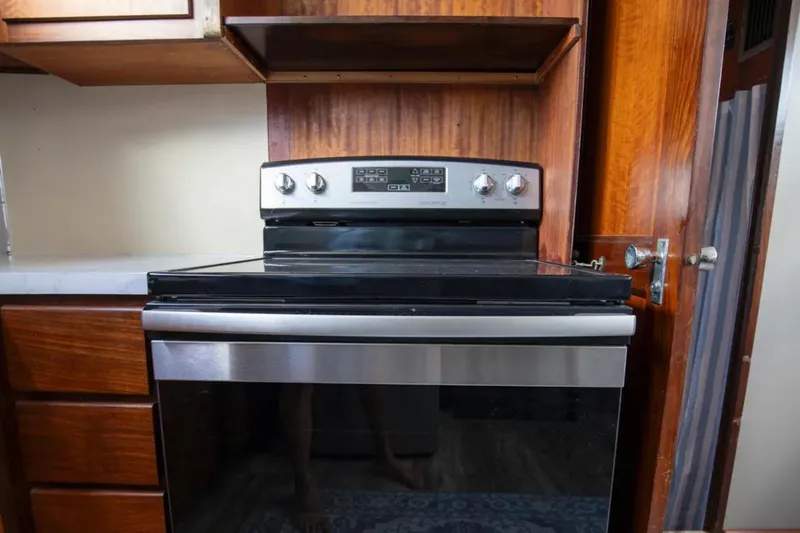 Slide: The Image of Stainless steel oven in 1973 Hatteras 58 Yacht Fisherman kitchen with wooden cabinetry. - 46