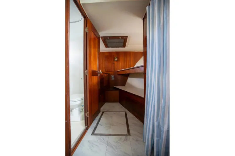 Slide: The Image of 1973 Hatteras 58 Yacht Fisherman interior with wood paneling and bunk beds. - 47