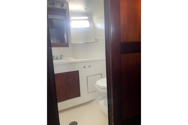 Slide: The Image of Bathroom interior of 1973 Hatteras 58 Yacht Fisherman with wooden accents and white fixtures. - 50