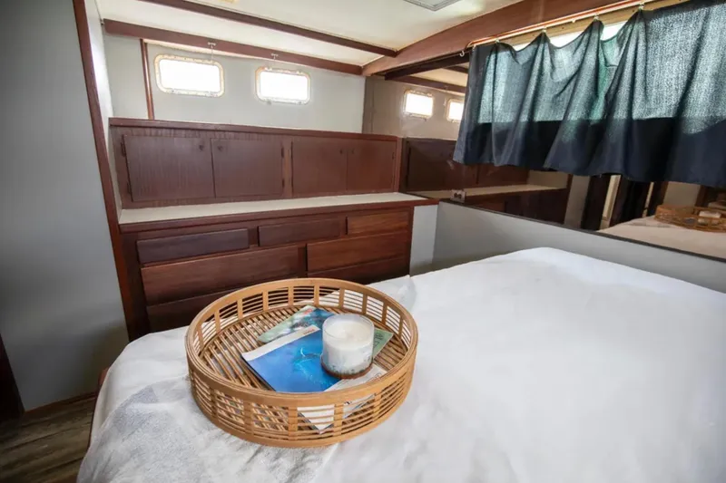 Slide: The Image of 1973 Hatteras 58 Yacht Fisherman bedroom with wooden cabinetry and decorative basket. - 55