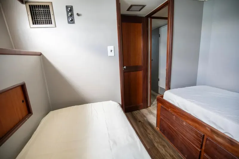 Slide: The Image of Interior cabin of 1973 Hatteras 58 Yacht Fisherman with twin beds and wooden accents. - 61