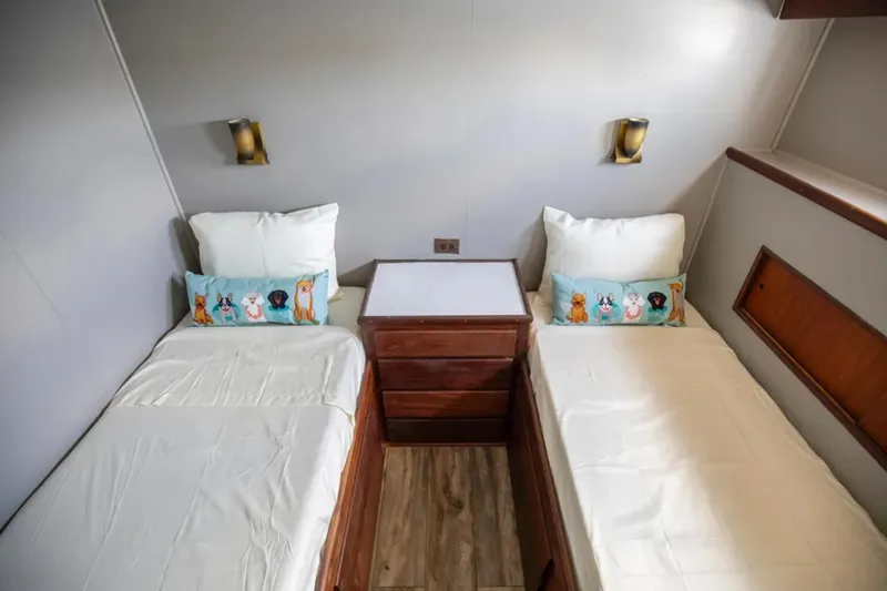 Slide: The Image of Cozy twin cabin on 1973 Hatteras 58 Yacht Fisherman with playful dog-themed pillows. - 62