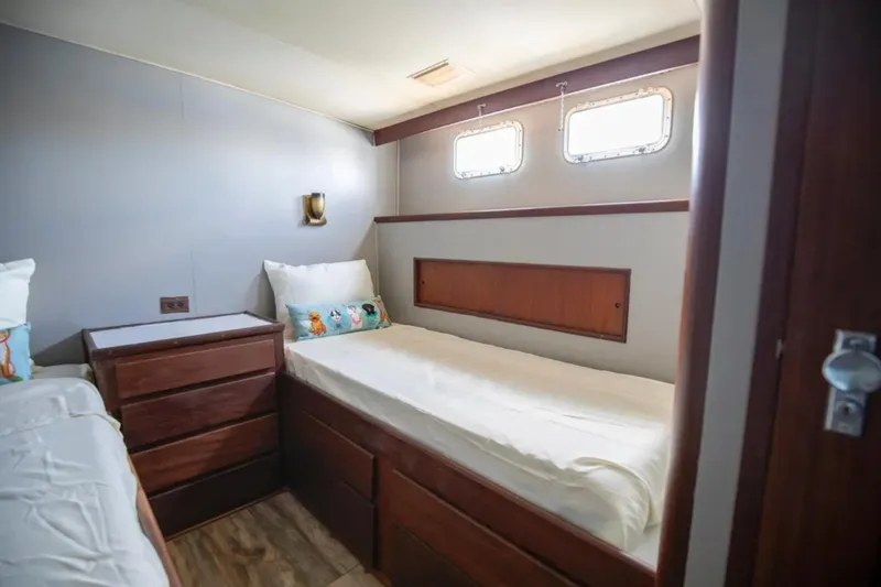 Slide: The Image of Cozy cabin interior of 1973 Hatteras 58 Yacht Fisherman with twin beds and wooden accents. - 64