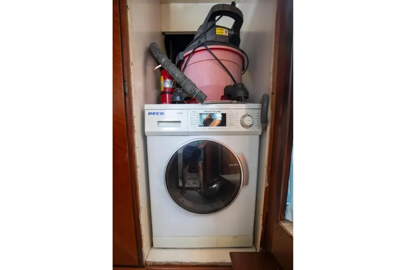 Slide: The Image of Washing machine and vacuum in a 1973 Hatteras 58 Yacht Fisherman storage area. - 67