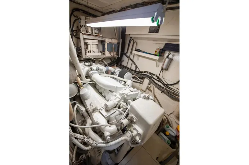Slide: The Image of Engine room of a 1973 Hatteras 58 Yacht Fisherman, showcasing mechanical components. - 69