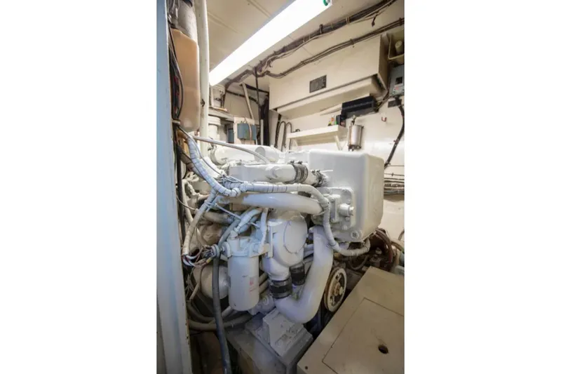Slide: The Image of Engine room of 1973 Hatteras 58 Yacht Fisherman, showcasing mechanical components and wiring. - 70