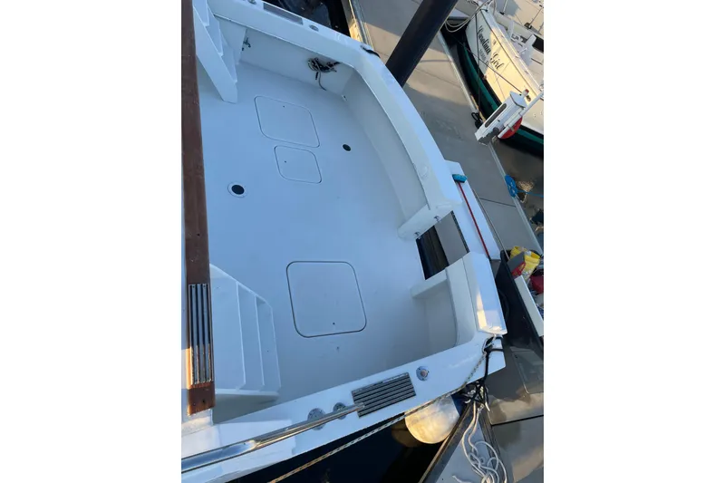 Slide: The Image of 1973 Hatteras 58 Yacht Fisherman deck view at marina, showcasing spacious layout. - 8