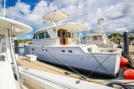 Slide: The Image of 1973 Hatteras 58 Yacht Fisherman docked at marina under a partly cloudy sky. - 9