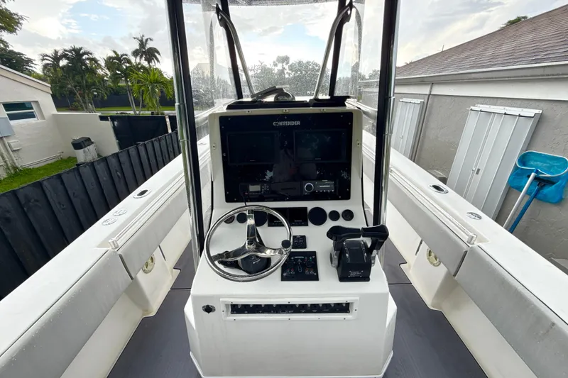 Slide: The Image of 2005 Contender 27 Open boat cockpit with steering wheel and control panel. - 11