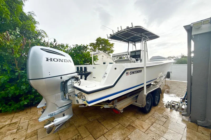 Slide: The Image of 2005 Contender 27 Open boat with Honda outboard motor on a trailer. - 6
