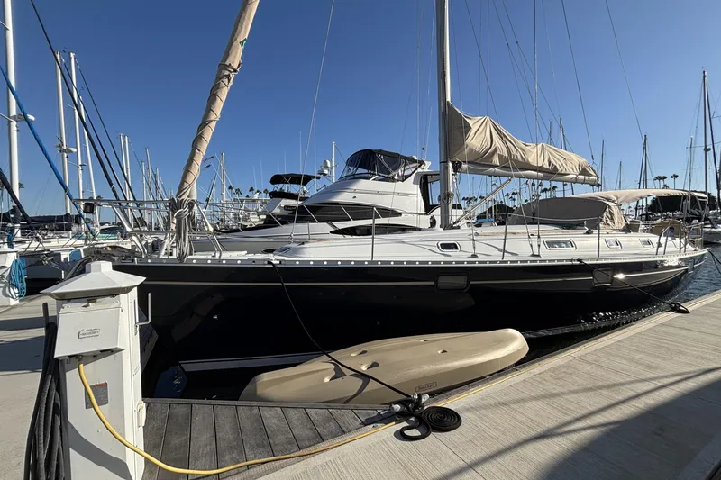 The Image of 1997 Beneteau Oceanis 400 sailboat docked at marina under clear blue sky. - 0