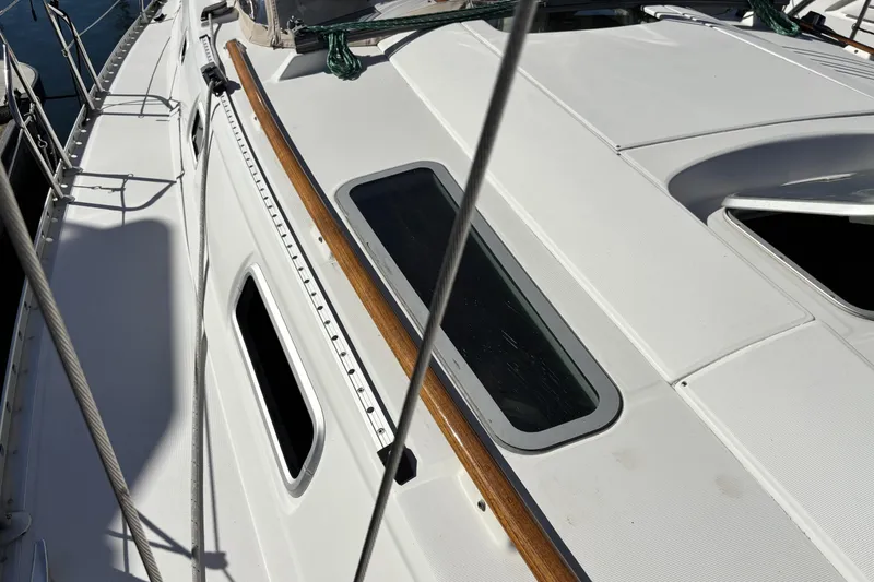 Slide: The Image of Deck view of 1997 Beneteau Oceanis 400 sailboat with sleek design and wooden accents. - 10