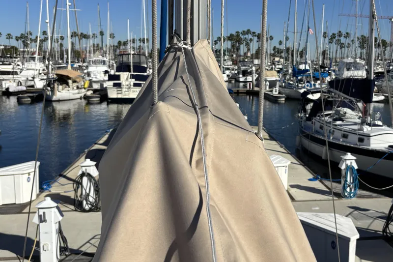 Slide: The Image of Beneteau Oceanis 400 sailboat docked at marina, surrounded by other boats, sunny day. - 17
