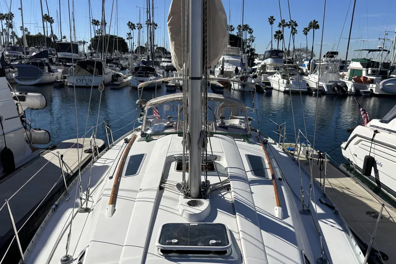 Slide: The Image of 1997 Beneteau Oceanis 400 sailboat docked in a marina with other boats. - 2