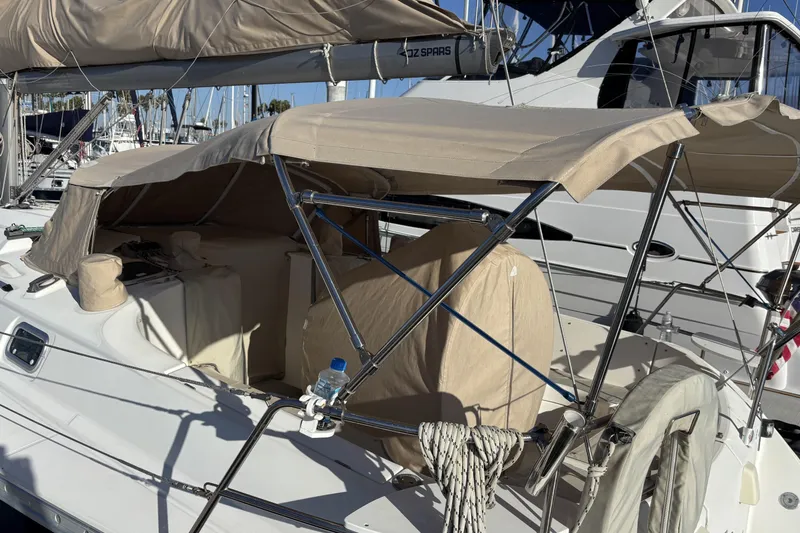 Slide: The Image of 1997 Beneteau Oceanis 400 sailboat with beige canopy docked at marina. - 27