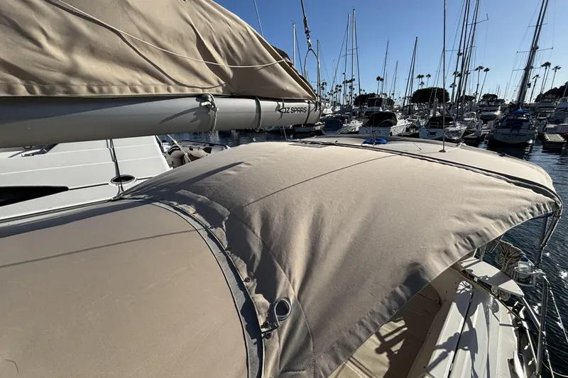 Slide: The Image of Beneteau Oceanis 400 sailboat, 1997 model, docked in a marina with beige canopy. - 28