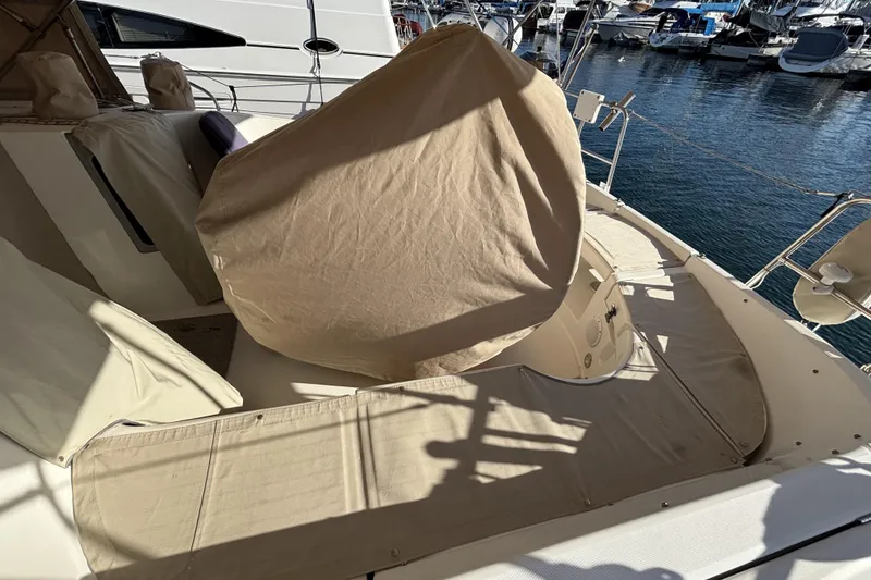 Slide: The Image of 1997 Beneteau Oceanis 400 sailboat deck with beige covers, docked at marina. - 29