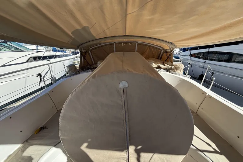 Slide: The Image of 1997 Beneteau Oceanis 400 sailboat cockpit with beige canvas cover, docked at marina. - 30