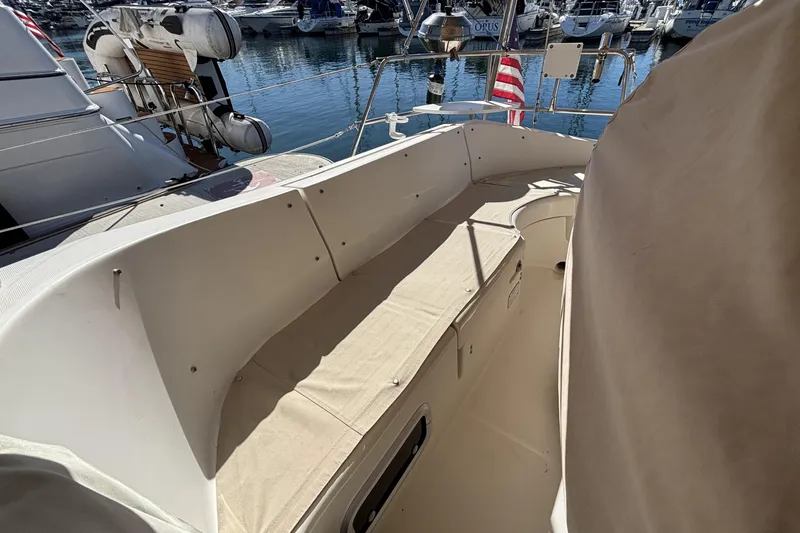 Slide: The Image of 1997 Beneteau Oceanis 400 sailboat cockpit with beige seating, docked at marina. - 31