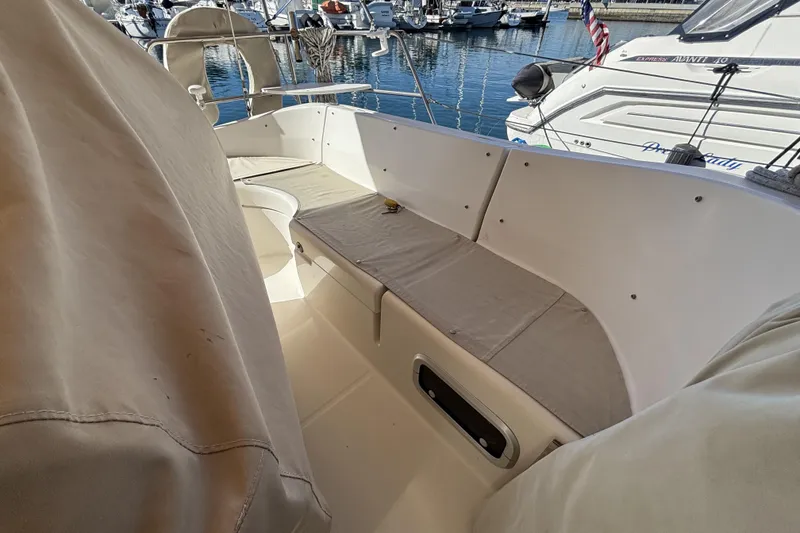 Slide: The Image of 1997 Beneteau Oceanis 400 sailboat cockpit with beige seating, docked in marina. - 34