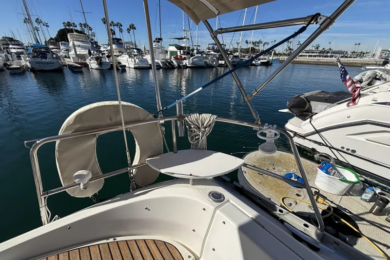 Slide: The Image of Beneteau Oceanis 400 sailboat docked in marina, 1997 model, with clear blue water. - 36