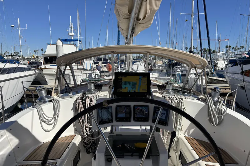 Slide: The Image of Cockpit view of a 1997 Beneteau Oceanis 400 sailboat docked in a marina. - 41