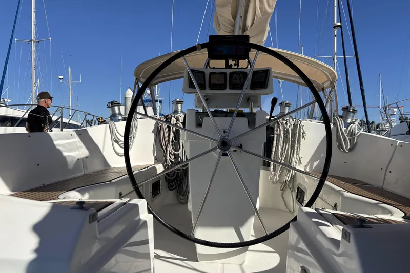 Slide: The Image of 1997 Beneteau Oceanis 400 sailboat cockpit with steering wheel and navigation instruments. - 45