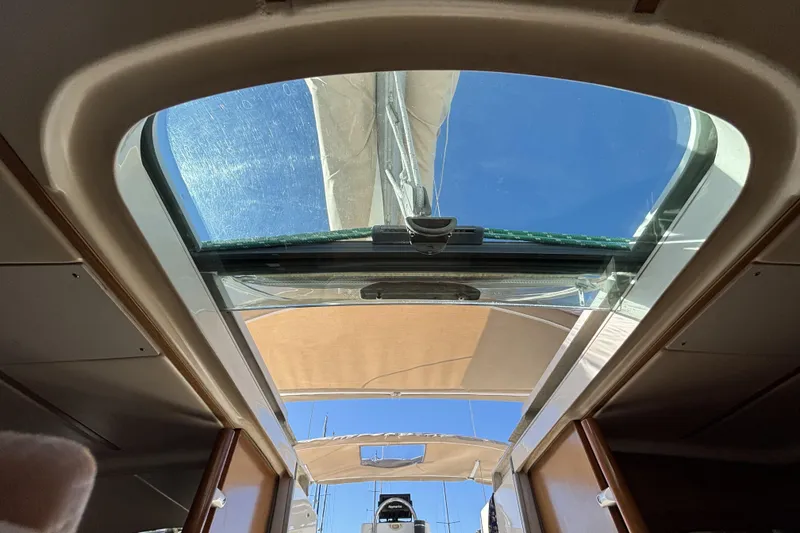 Slide: The Image of Interior view of 1997 Beneteau Oceanis 400 sailboat with open hatch and clear sky. - 53