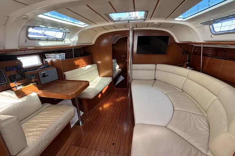 Slide: The Image of Interior of 1997 Beneteau Oceanis 400 yacht with elegant seating and wooden finishes. - 54