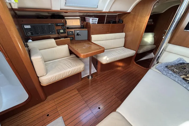 Slide: The Image of Interior of 1997 Beneteau Oceanis 400 yacht with wood paneling and cream seating. - 55