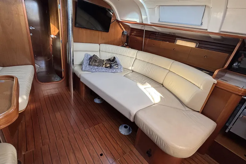 Slide: The Image of Interior of 1997 Beneteau Oceanis 400 yacht with cream leather seating and wooden flooring. - 58
