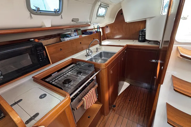 Slide: The Image of Interior of 1997 Beneteau Oceanis 400 yacht kitchen with stove, sink, and microwave. - 65