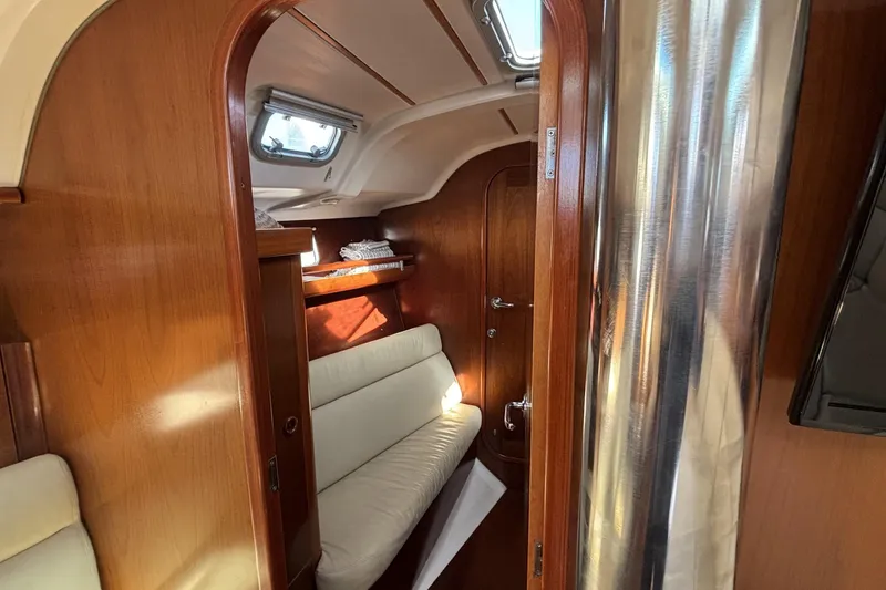 Slide: The Image of Interior of 1997 Beneteau Oceanis 400 sailboat with wooden finish and cozy seating. - 72