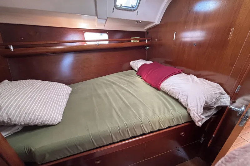 Slide: The Image of Cozy cabin interior of 1997 Beneteau Oceanis 400 sailboat with wooden finish and bedding. - 73