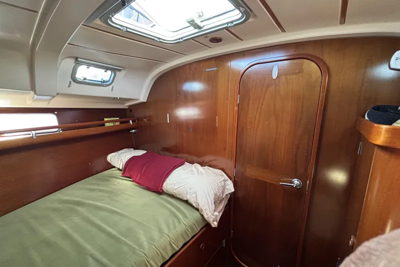 Slide: The Image of Cozy cabin interior of 1997 Beneteau Oceanis 400 sailboat with wooden finish and bedding. - 74